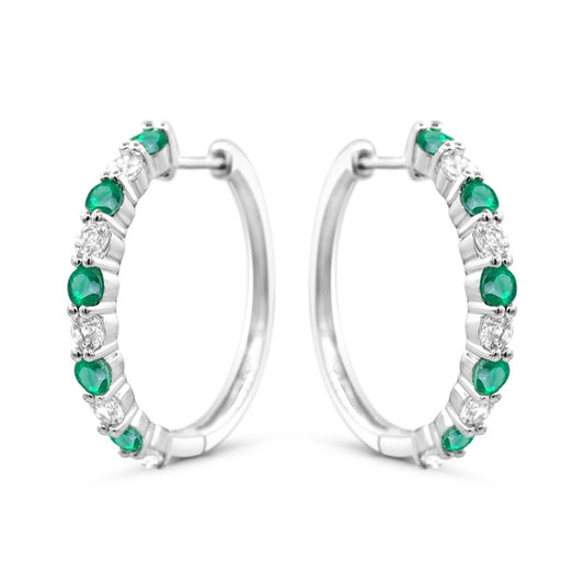Sterling silver hoops with simulated emeralds.