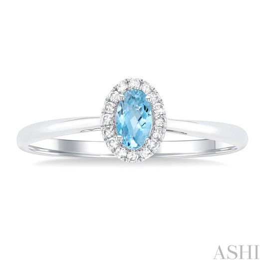 Oval aquamarine ring with diamond halo.