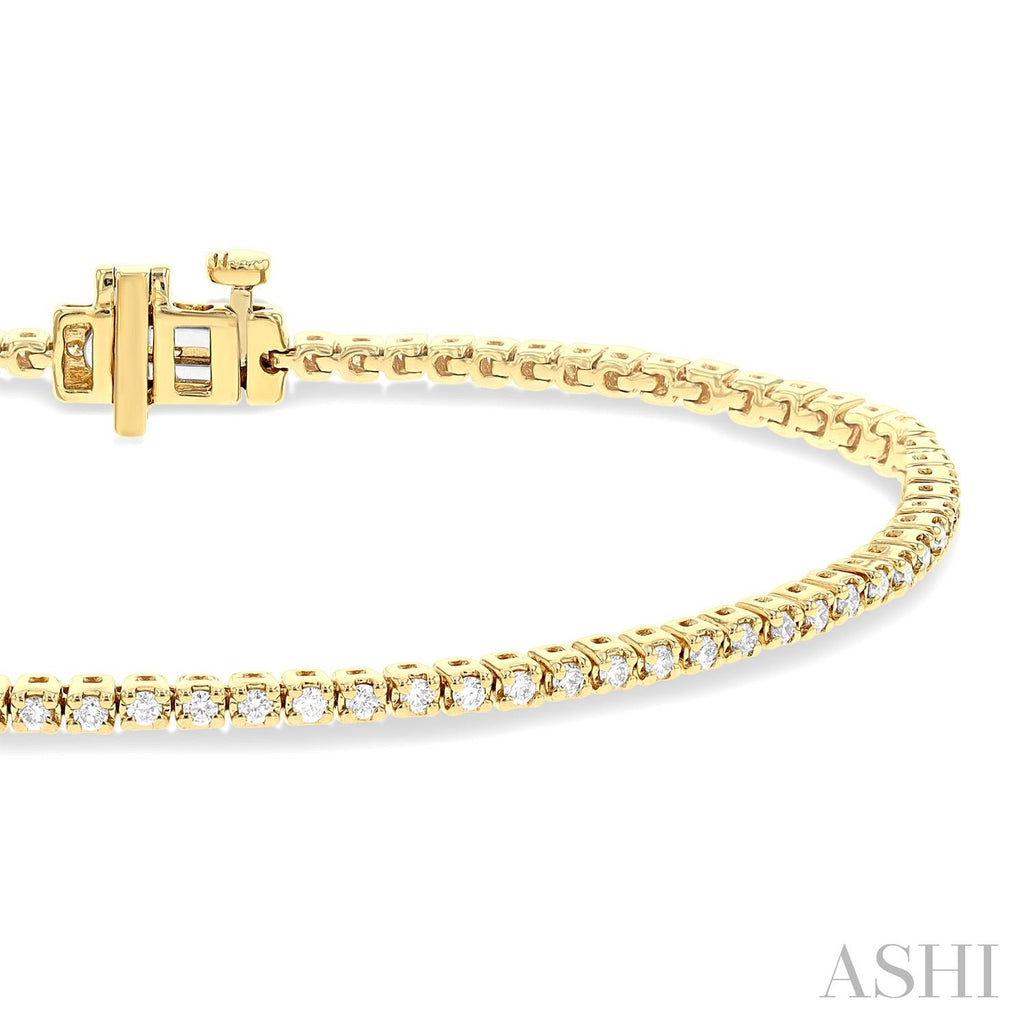 14K yellow gold diamond tennis bracelet.