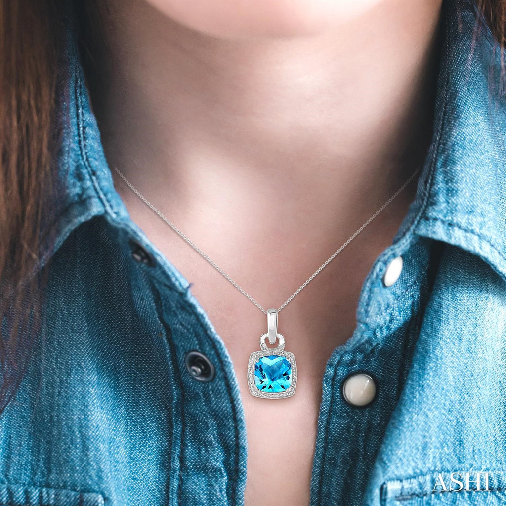 Cushion blue topaz pendant on silver chain.