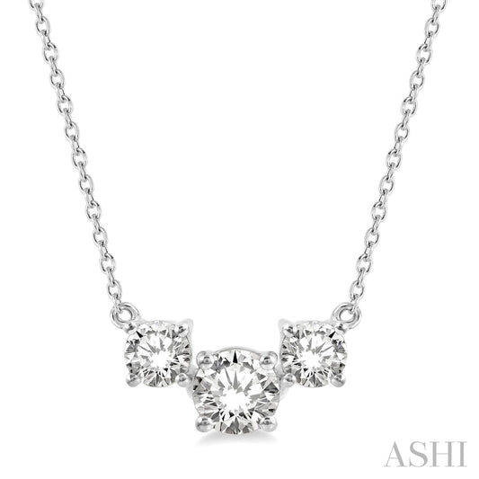 Three round diamonds on white gold necklace.