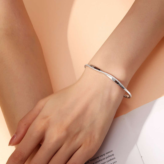 Simulated diamond bangle on wrist.