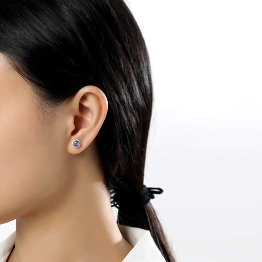 Amethyst stud earrings on ear.