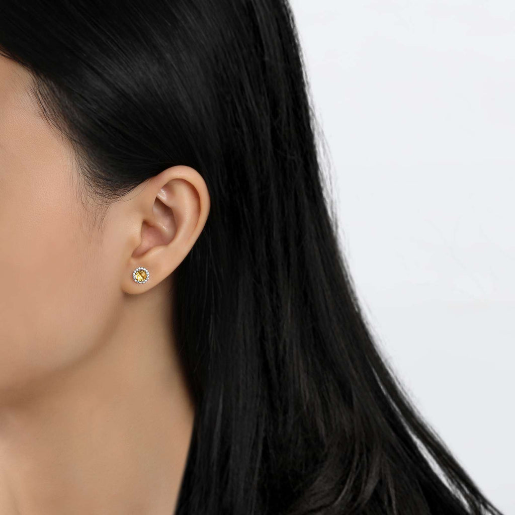 Round citrine stud earrings with simulated diamonds.