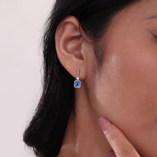 Emerald-cut blue topaz earrings.