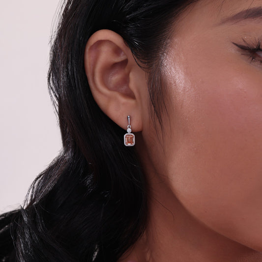 Emerald citrine earrings with diamond accents.