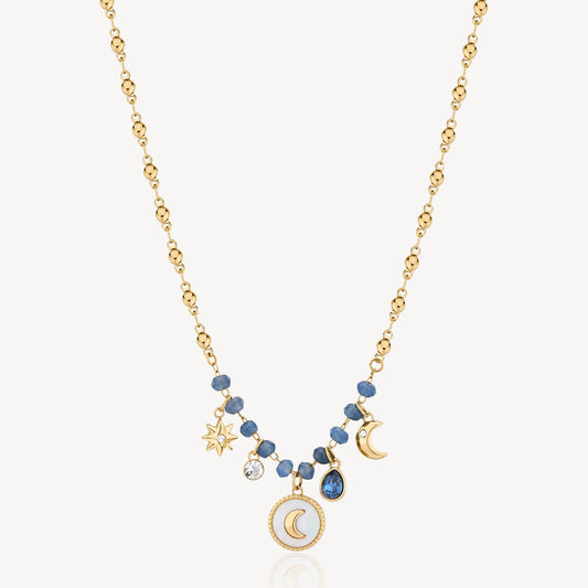 Gold necklace with blue gemstones and charms.