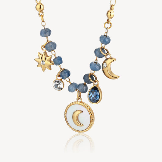 Gold necklace with blue gemstones and charms.