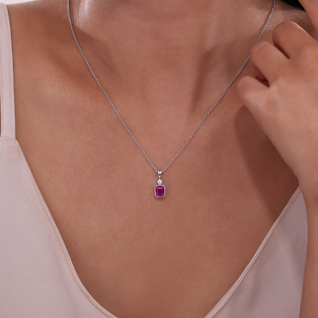 Simulated ruby pendant on silver chain.
