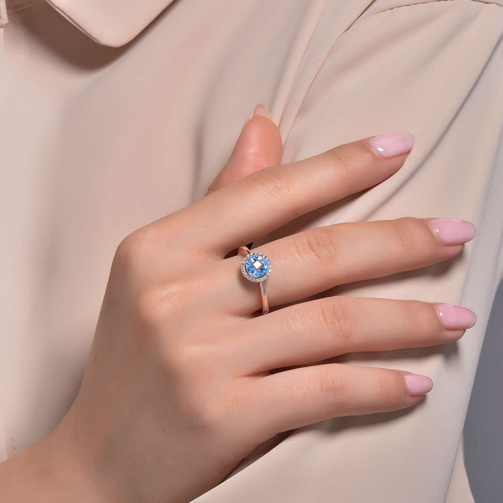 Blue topaz ring with simulated diamond halo.