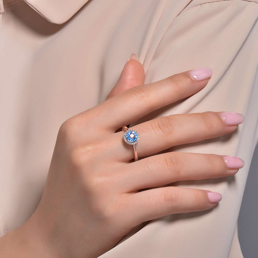 Blue topaz ring with simulated diamond halo.