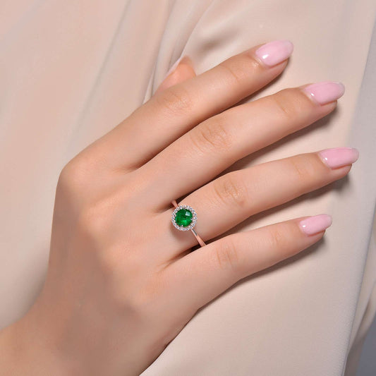 Simulated emerald ring with diamond accents.