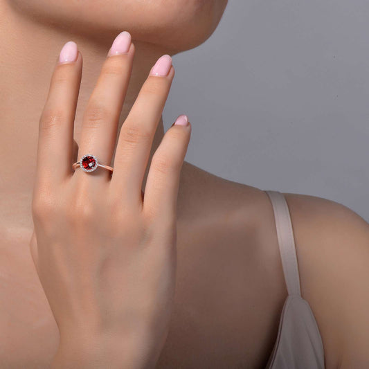 Garnet ring on hand, platinum bonded silver.