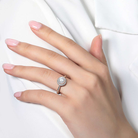 White pearl ring with simulated diamond halo.