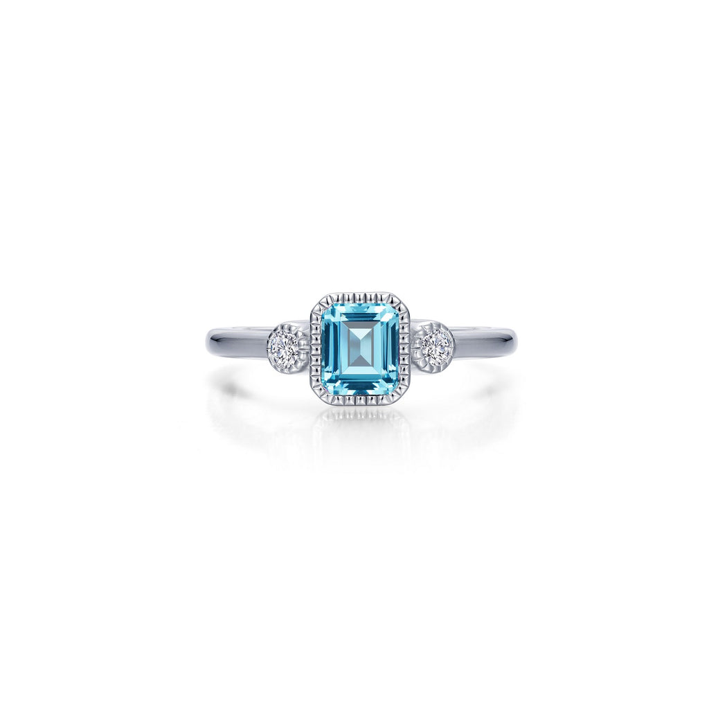Emerald-cut aquamarine ring with round accents.
