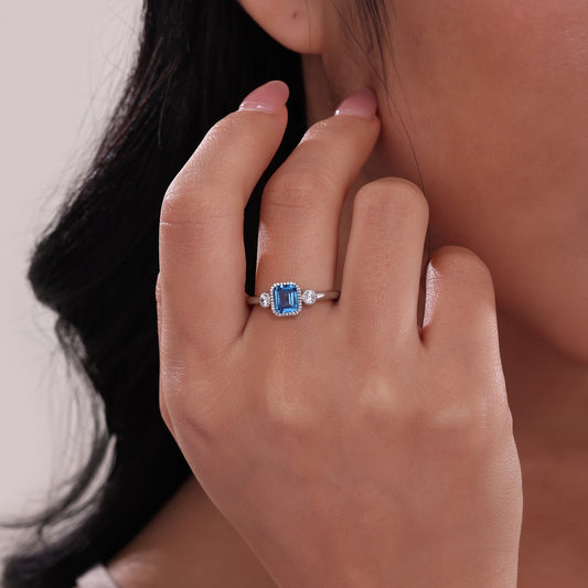 Emerald-cut blue topaz ring with diamonds.