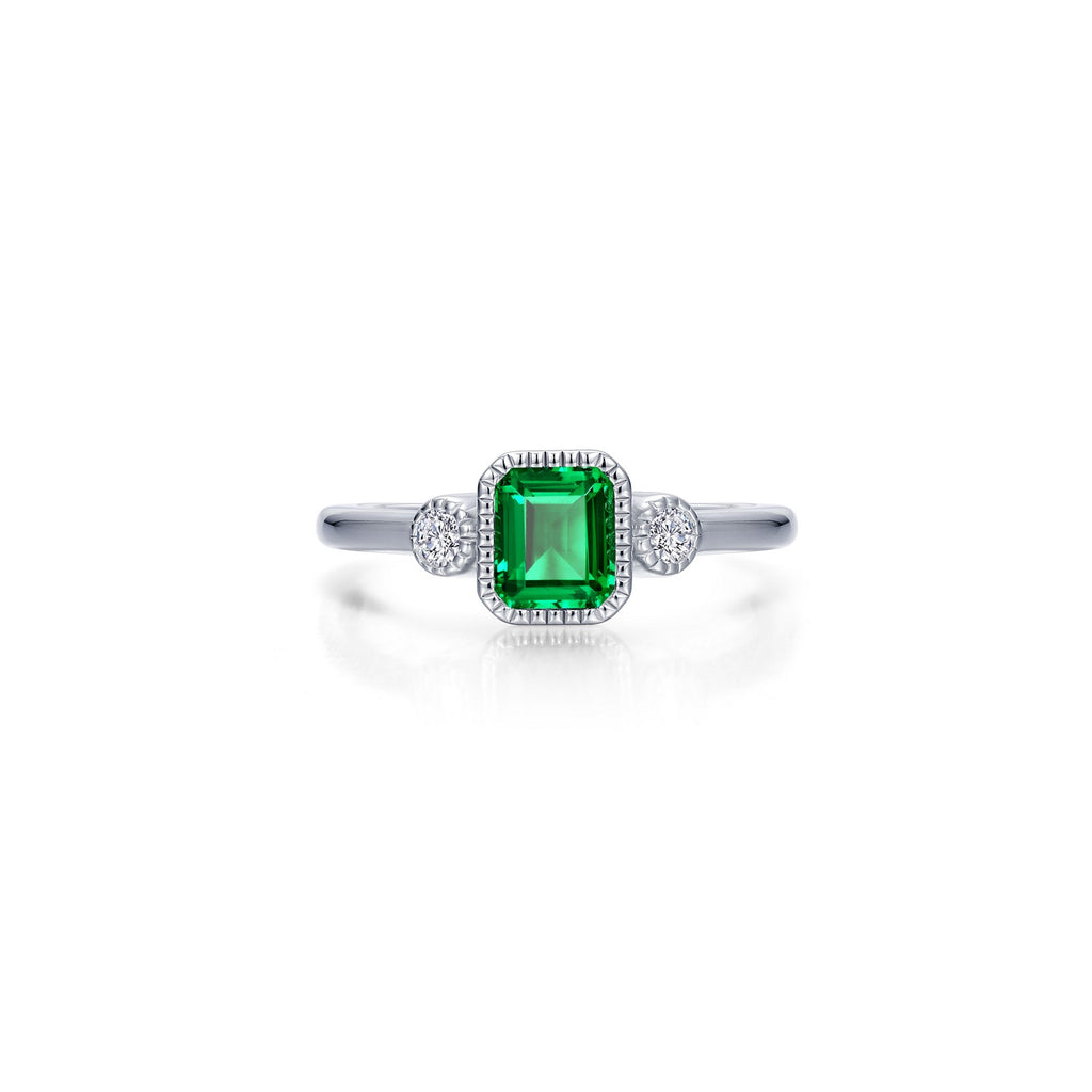 Emerald ring with diamond accents in silver.