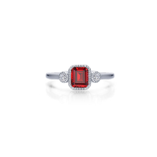 Emerald-cut red gemstone ring with diamonds.