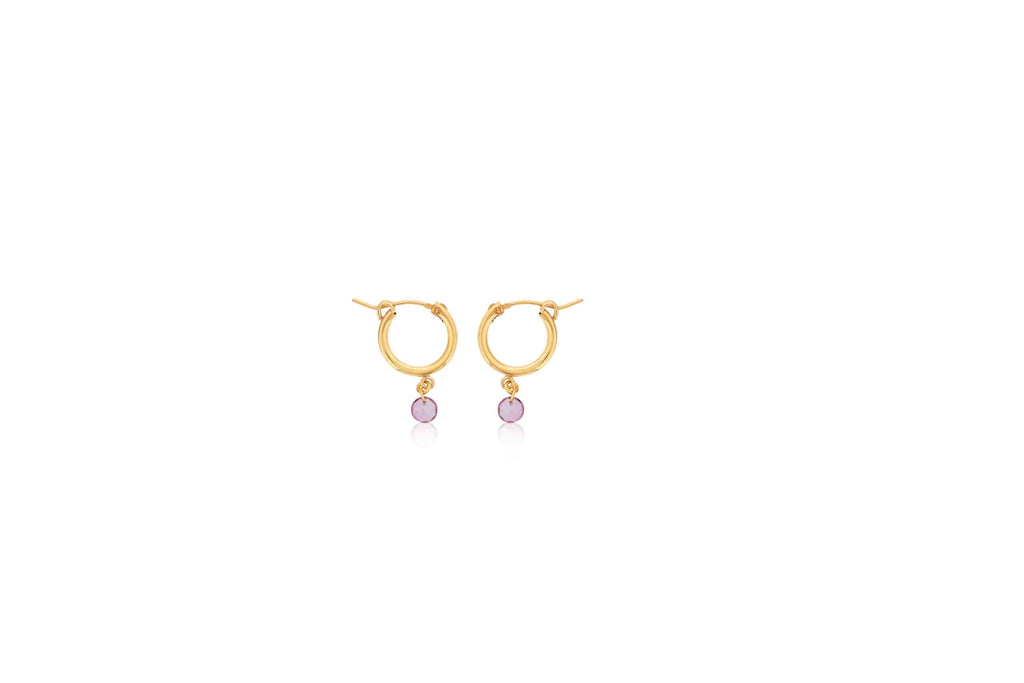 Gold hoop earrings with pink gemstones.