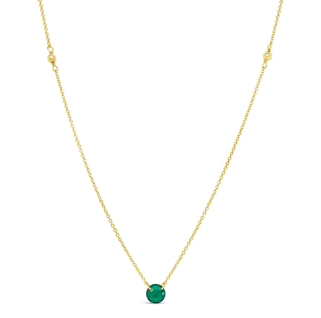 Gold necklace with round emerald pendant.