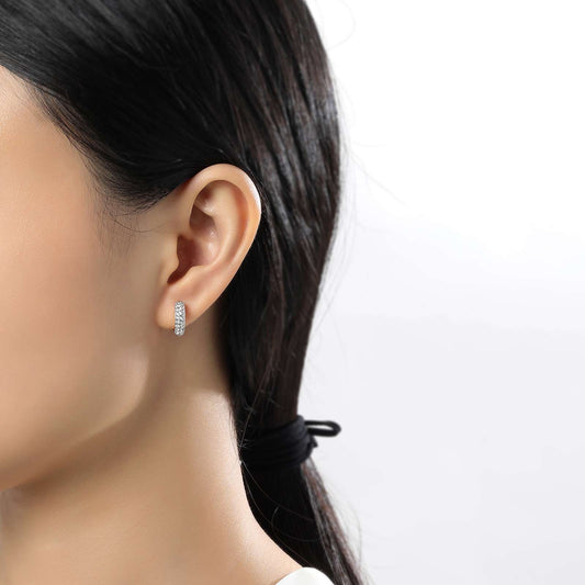 Simulated diamond huggie earrings on ear.
