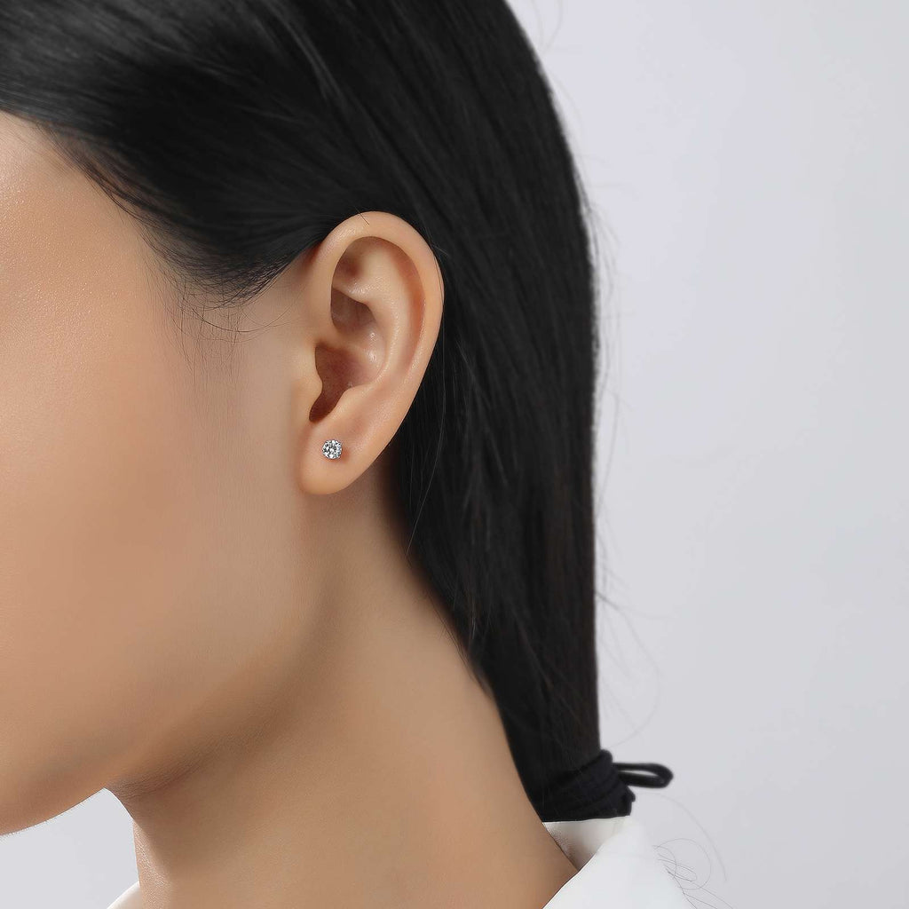 Simulated diamond stud earrings on ear.