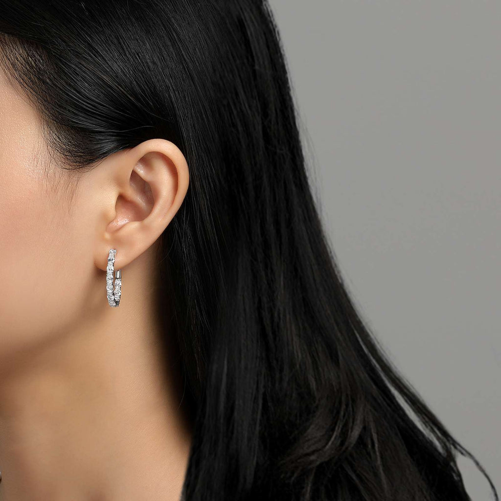 Platinum hoop earrings with simulated diamonds.