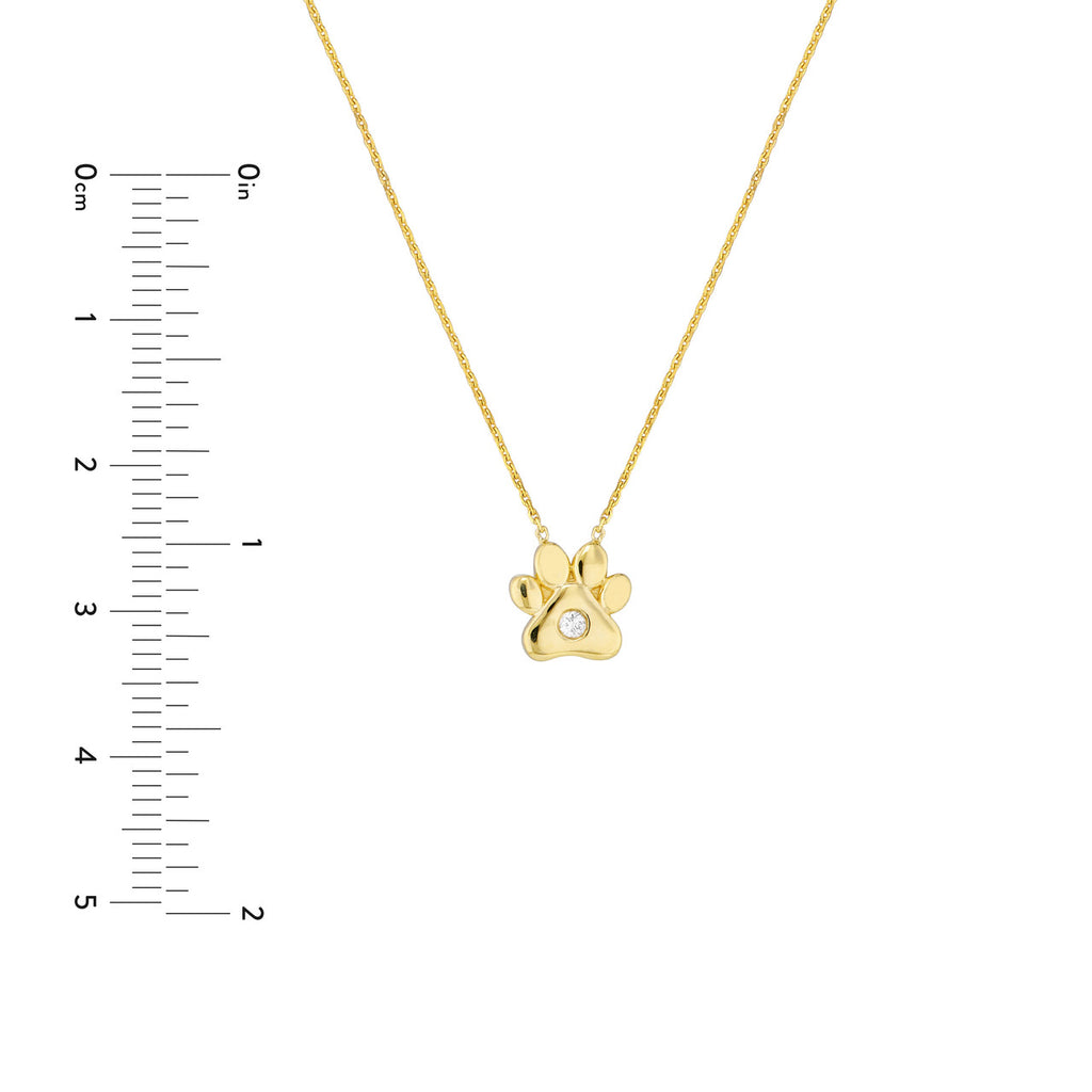 Gold paw pendant with diamond center.
