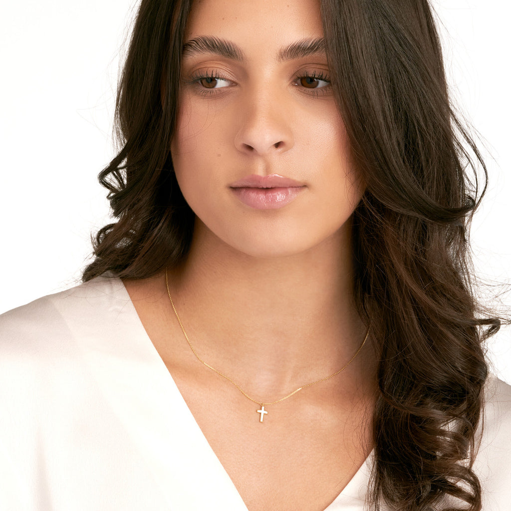 14K yellow enamel cross necklace on model.