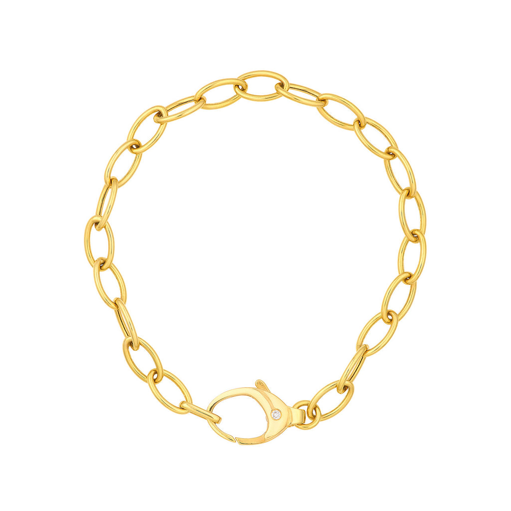 Yellow gold oval link bracelet with diamond.