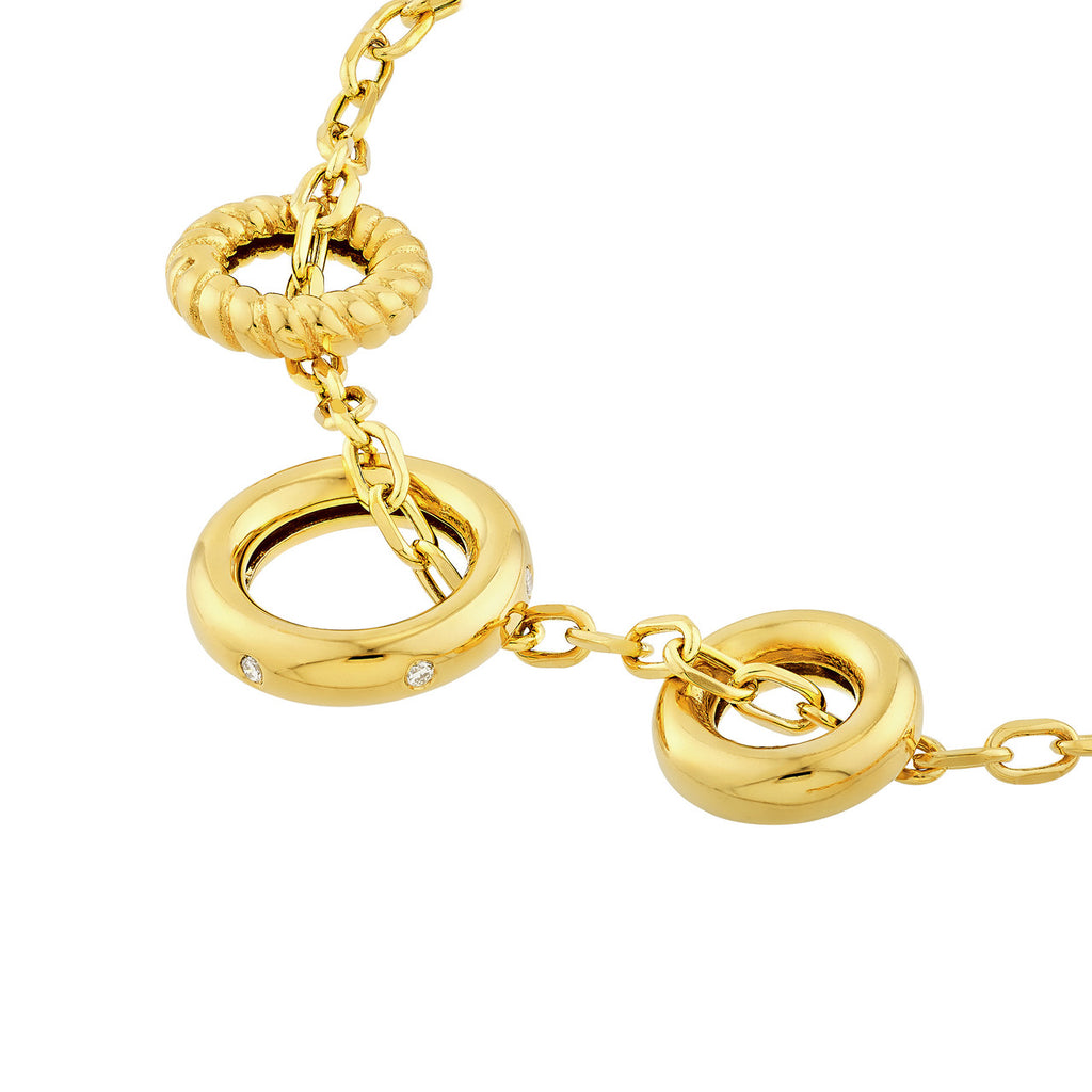Yellow gold necklace with diamond-accented rings.