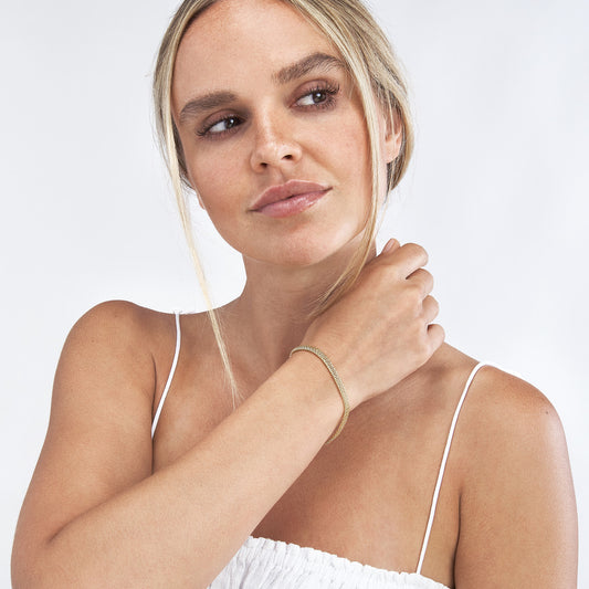 14K yellow gold bracelet on wrist.