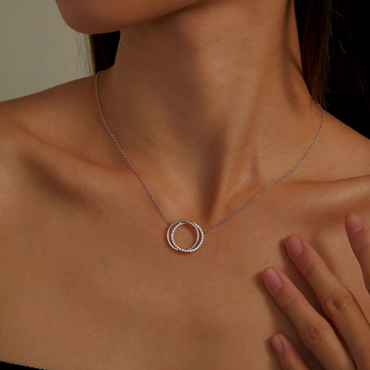Simulated diamond circle necklace on model.