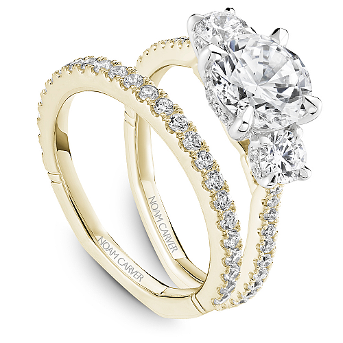 Three-stone diamond ring with hidden accents.