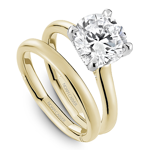 Two-tone gold ring with round diamond accents.