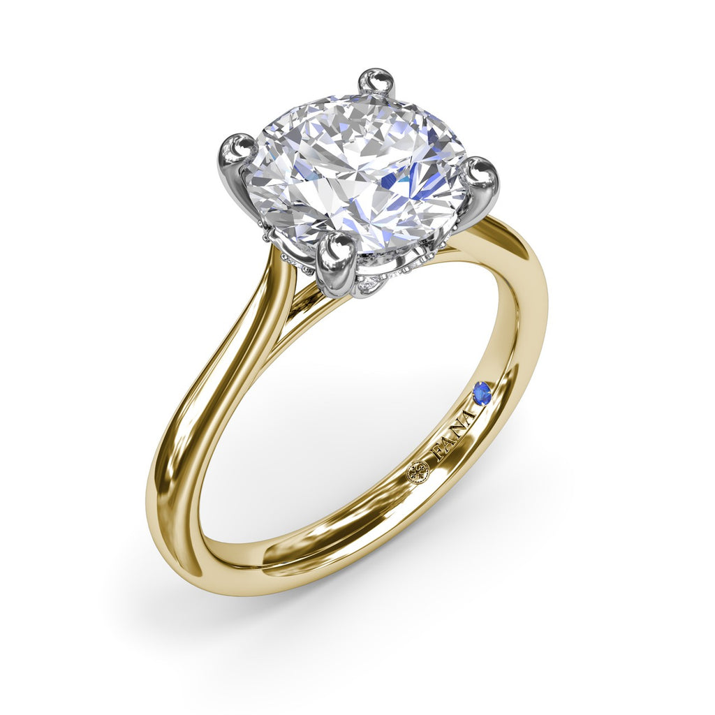 Yellow gold solitaire ring with round diamond.