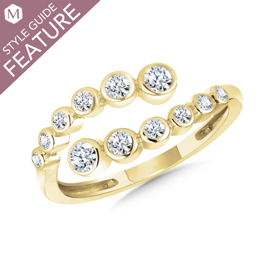 Yellow gold ring with round diamond accents.