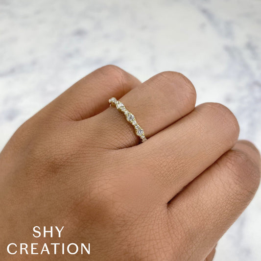 Yellow gold diamond band on finger.