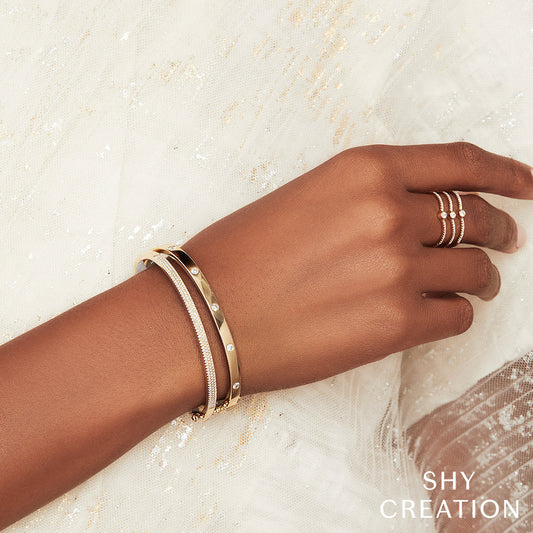 Rose gold diamond bangle on wrist.