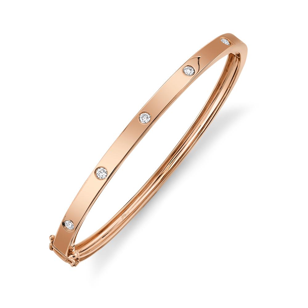 Rose gold bangle with round diamonds.