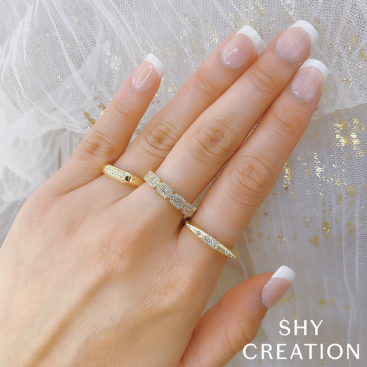 Diamond band with various shapes in gold.