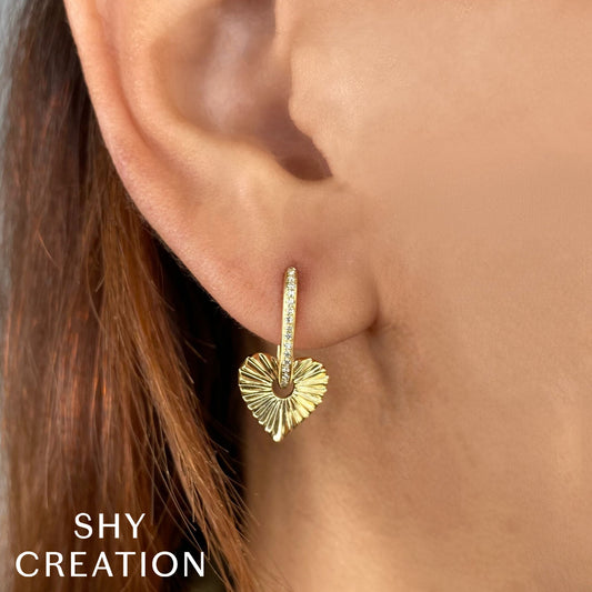 Gold dangle earrings with diamond accents.