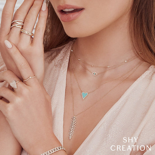 Turquoise heart necklace with diamond accents.