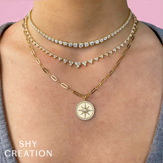 14K gold necklace with round diamonds.