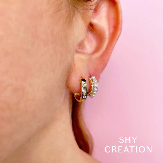 Yellow gold huggie earrings with pearls.