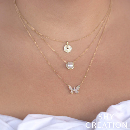 Diamond butterfly pendant on yellow gold chain.
