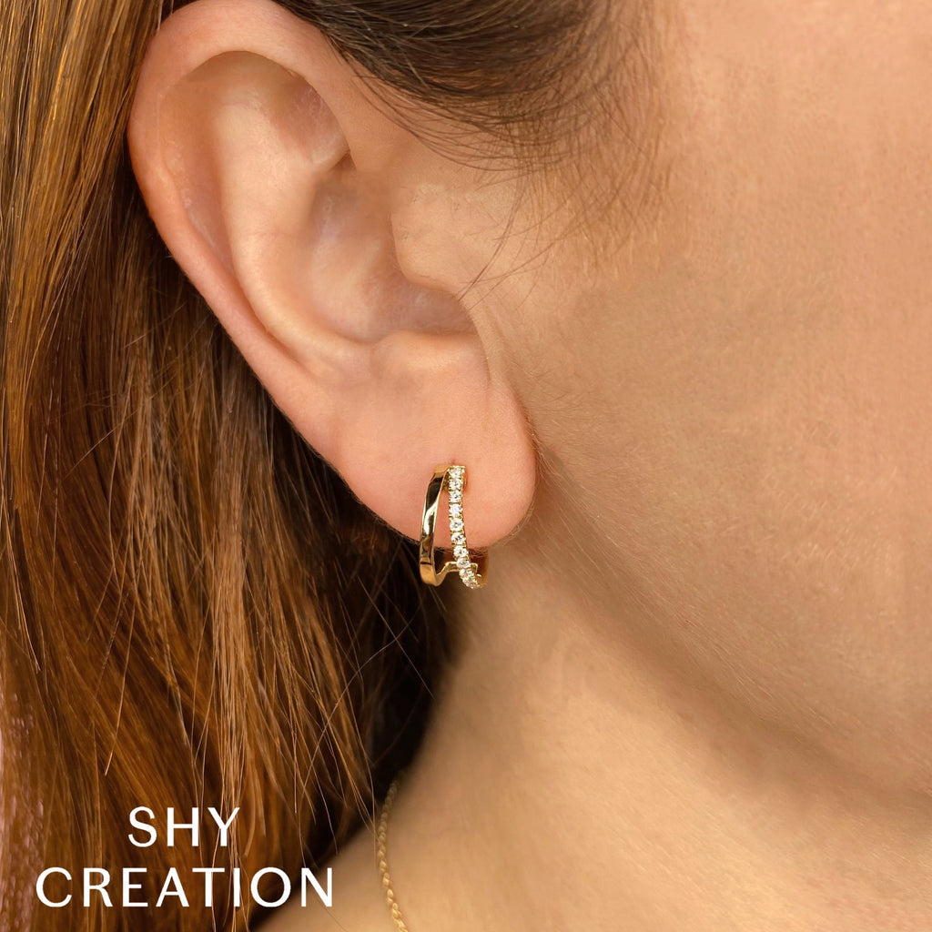 Yellow gold hoop earrings with round diamonds.