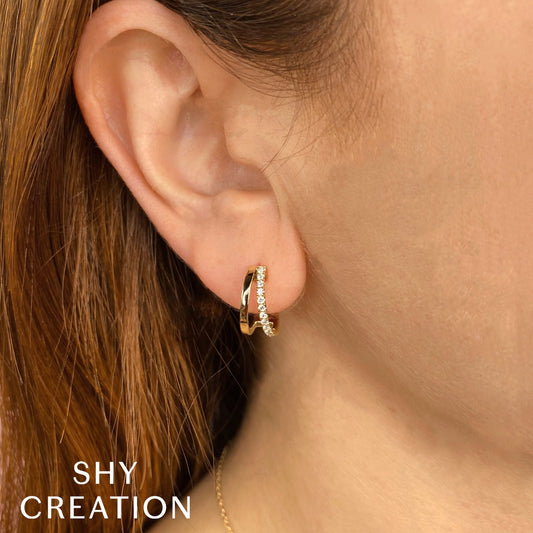 Yellow gold hoop earrings with round diamonds.