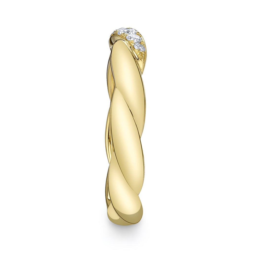Twisted yellow gold band with diamonds.