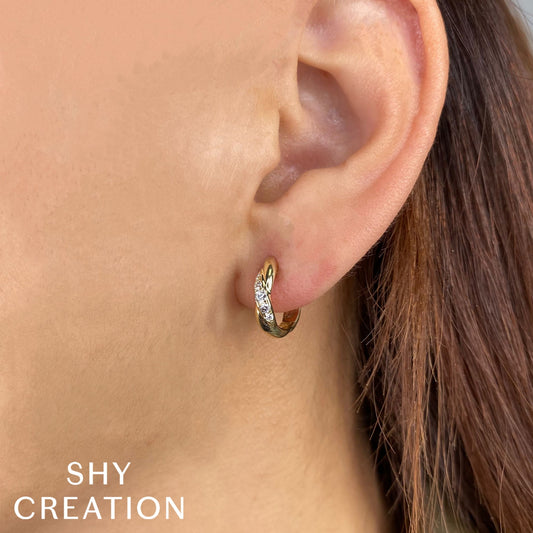 Huggie earrings with round diamonds.